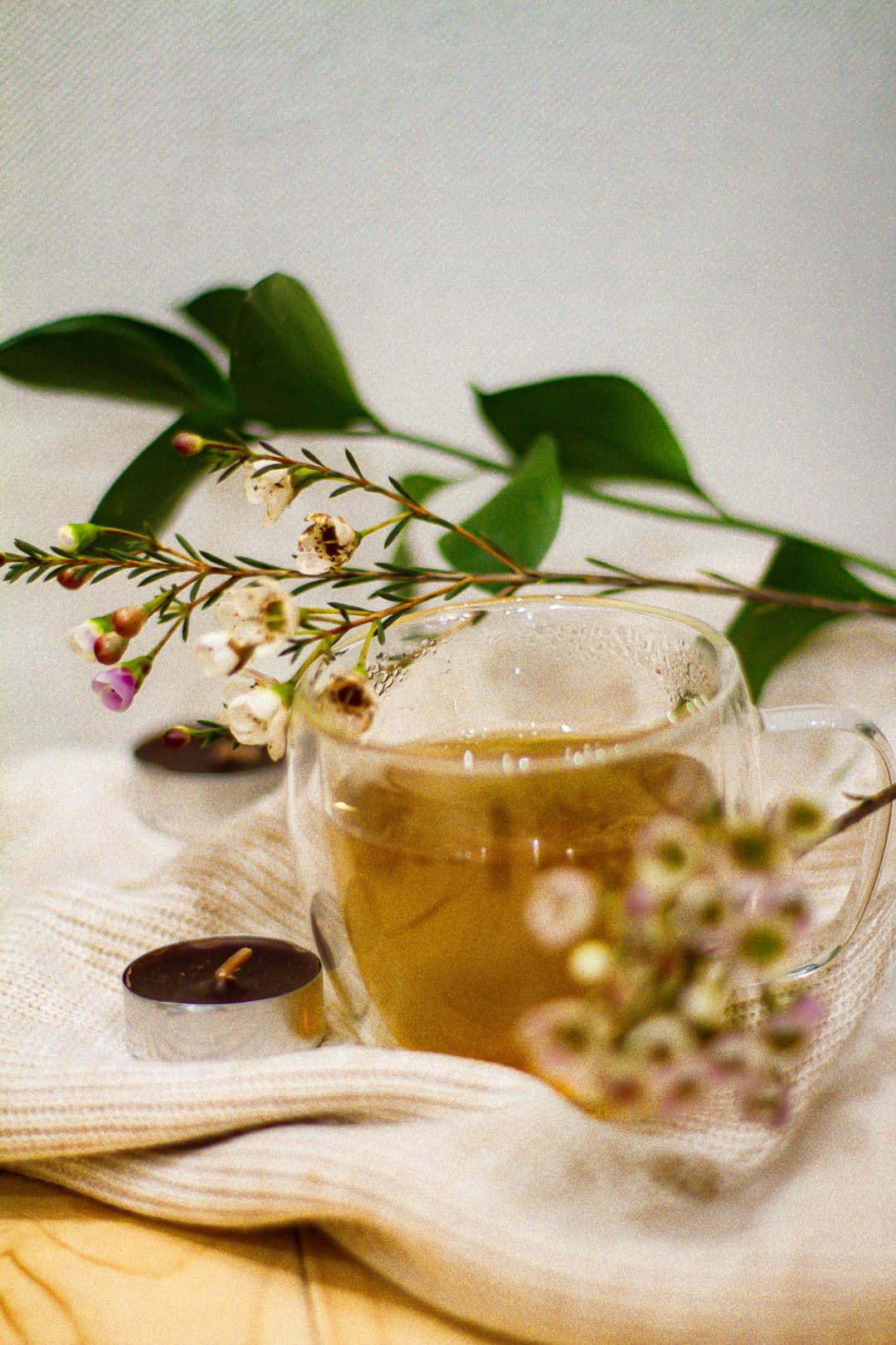 Herbal tea in a glass mug with flowers