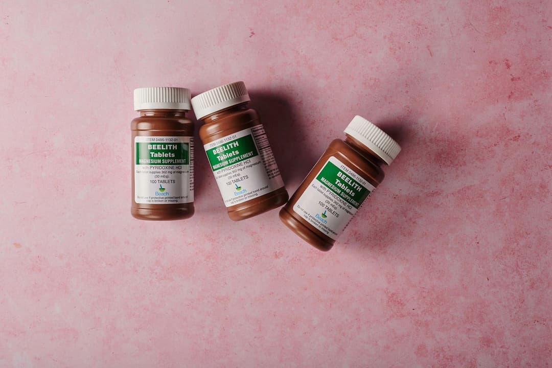 Three brown supplement bottles of magnesium tablets