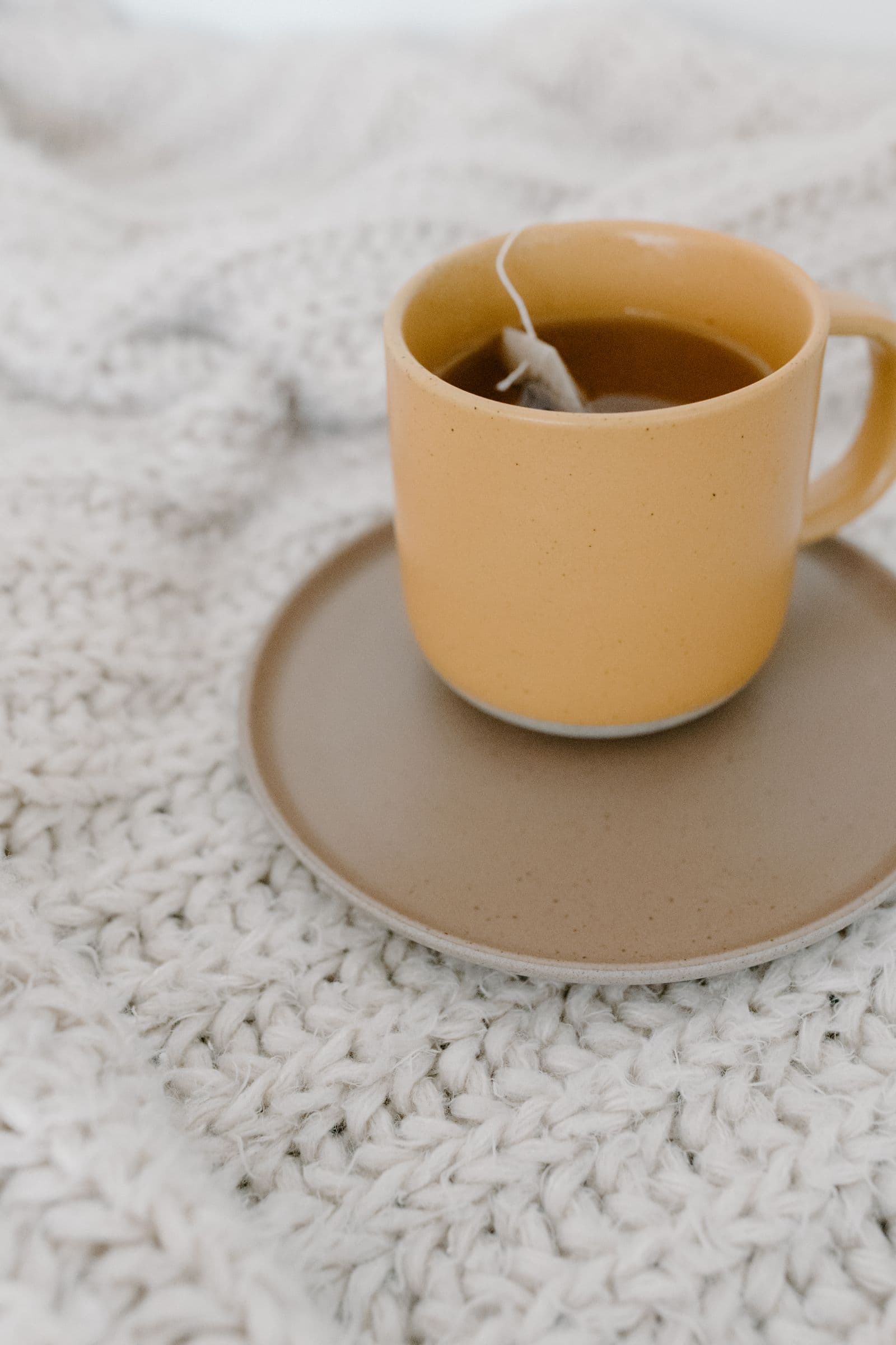 Cup of tea on a knitted blanket