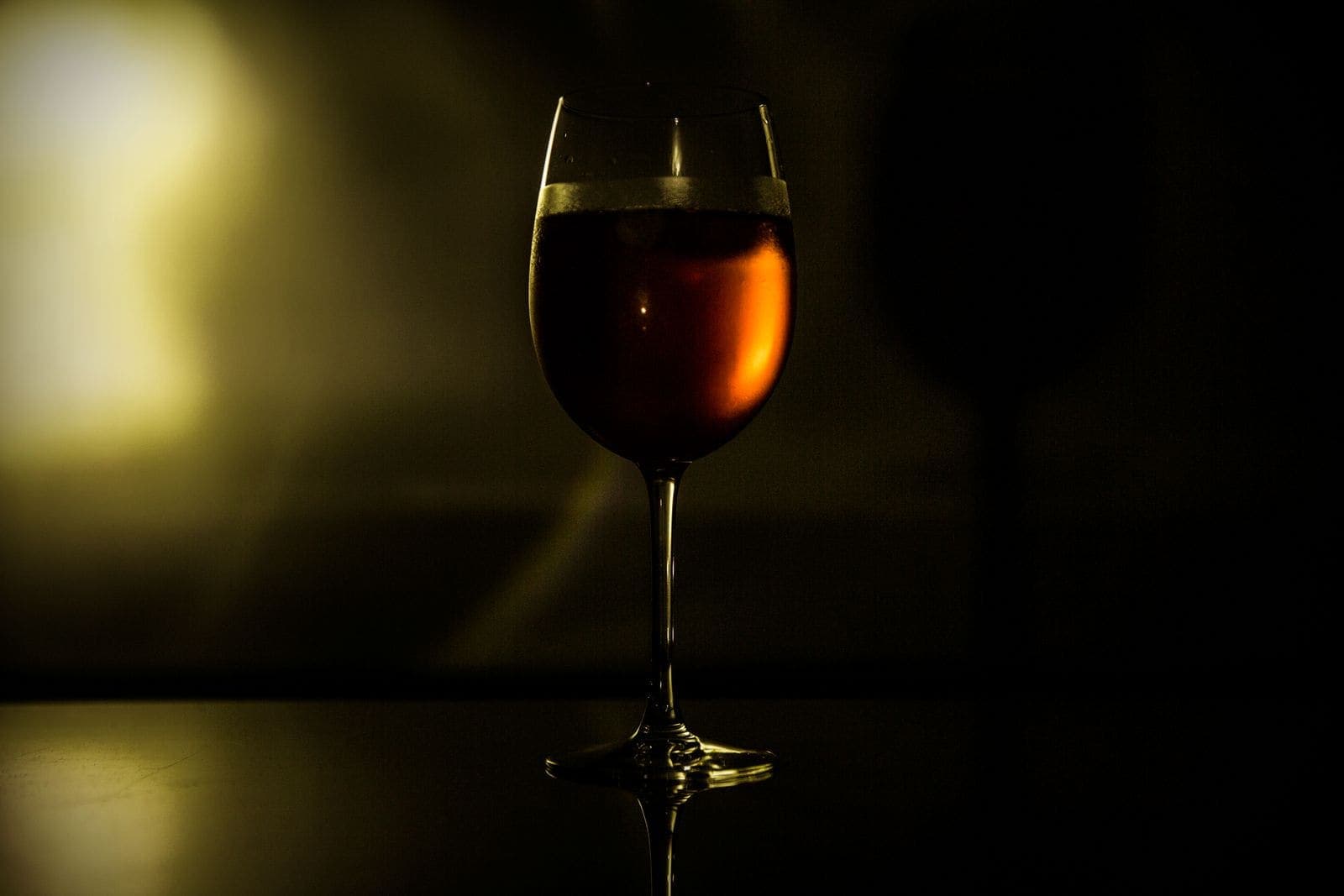 Glass of red wine in dim evening light