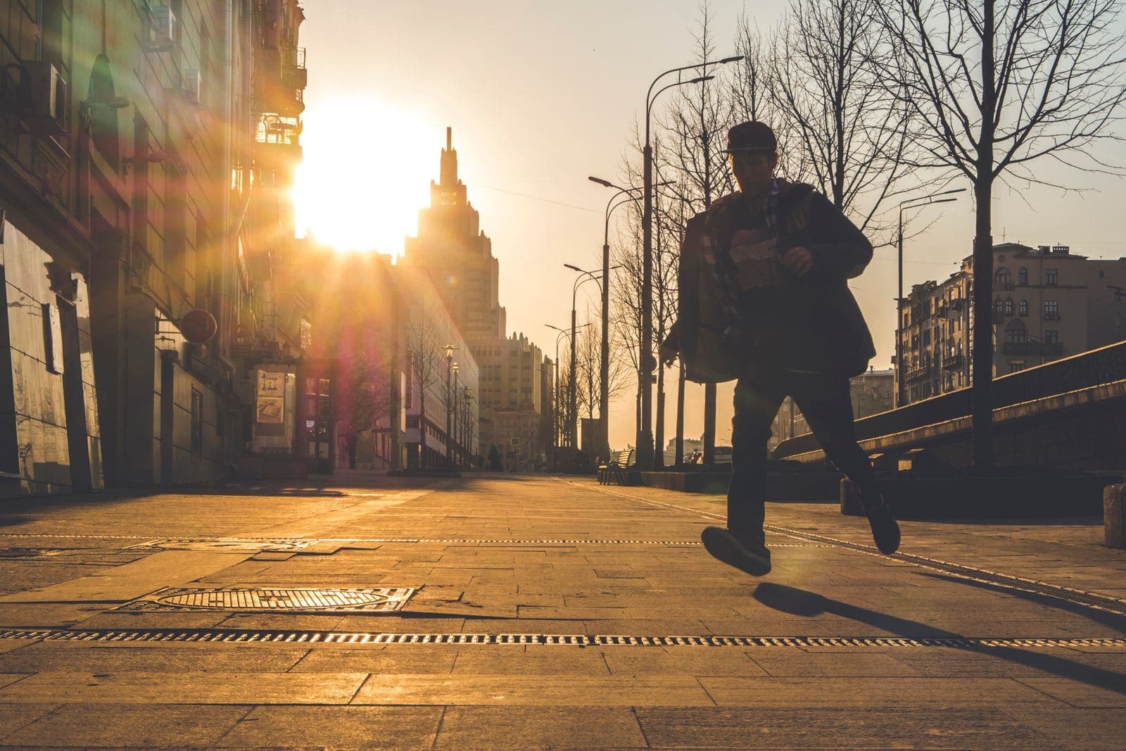 Runner on a city street at sunset