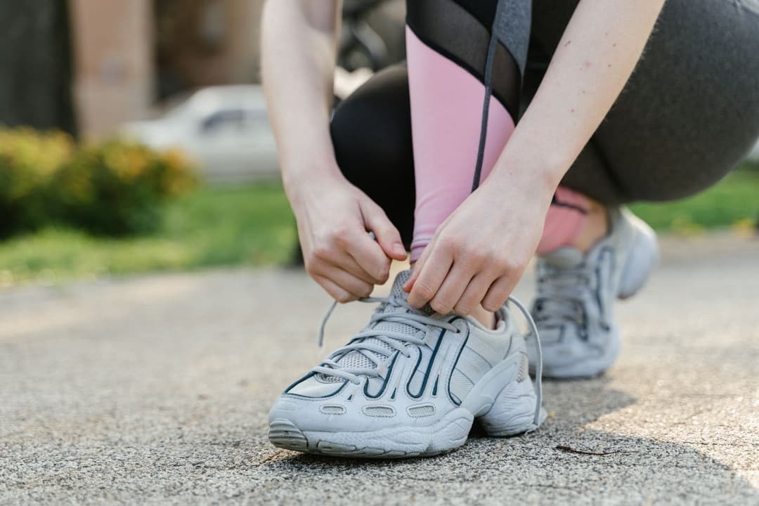 Runner tying a shoelace before a run