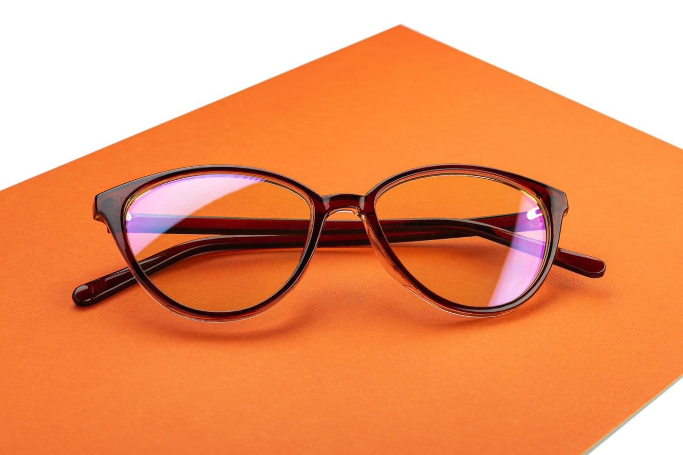 Glasses with a brown frame on an orange surface