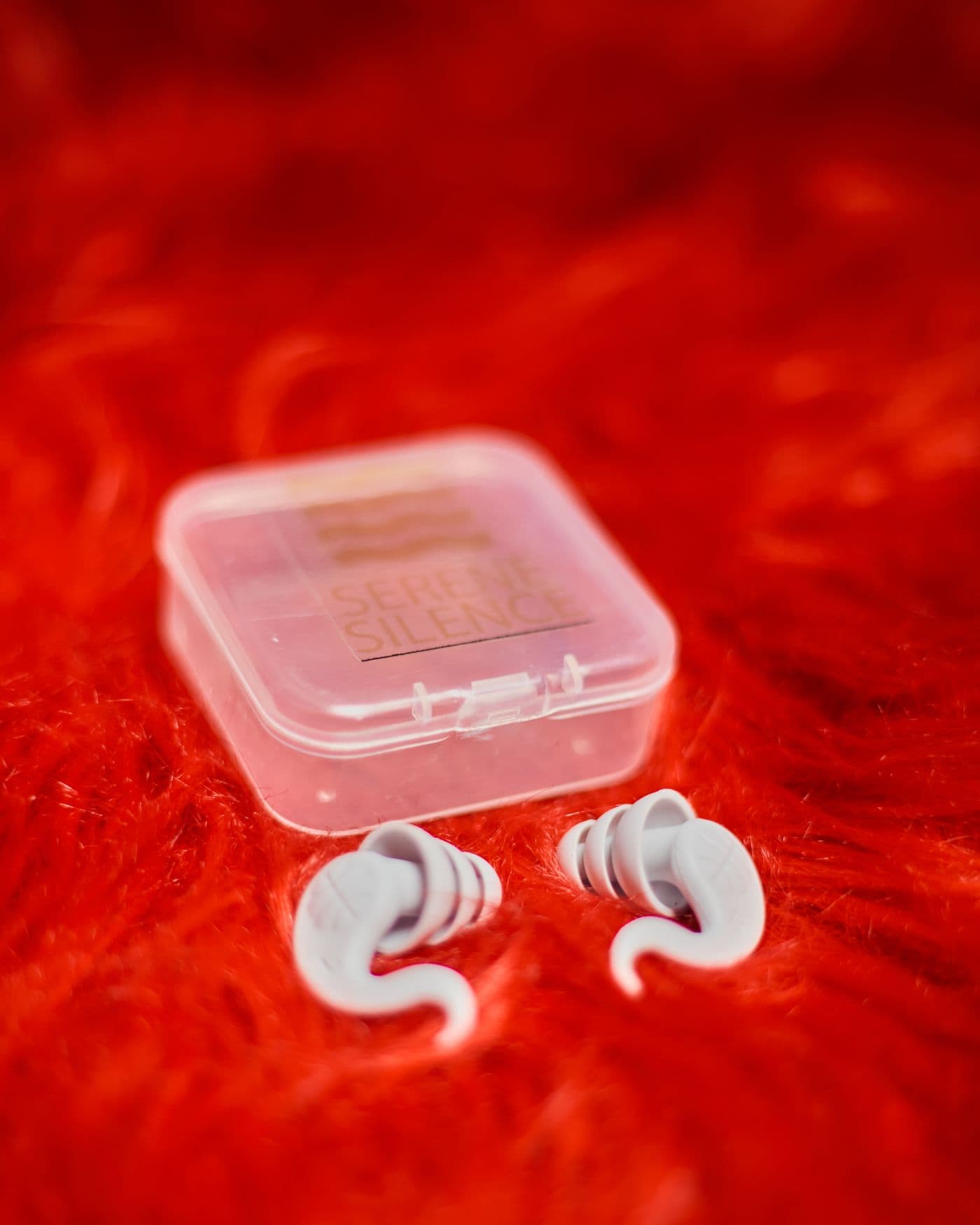 Earplugs beside a clear case