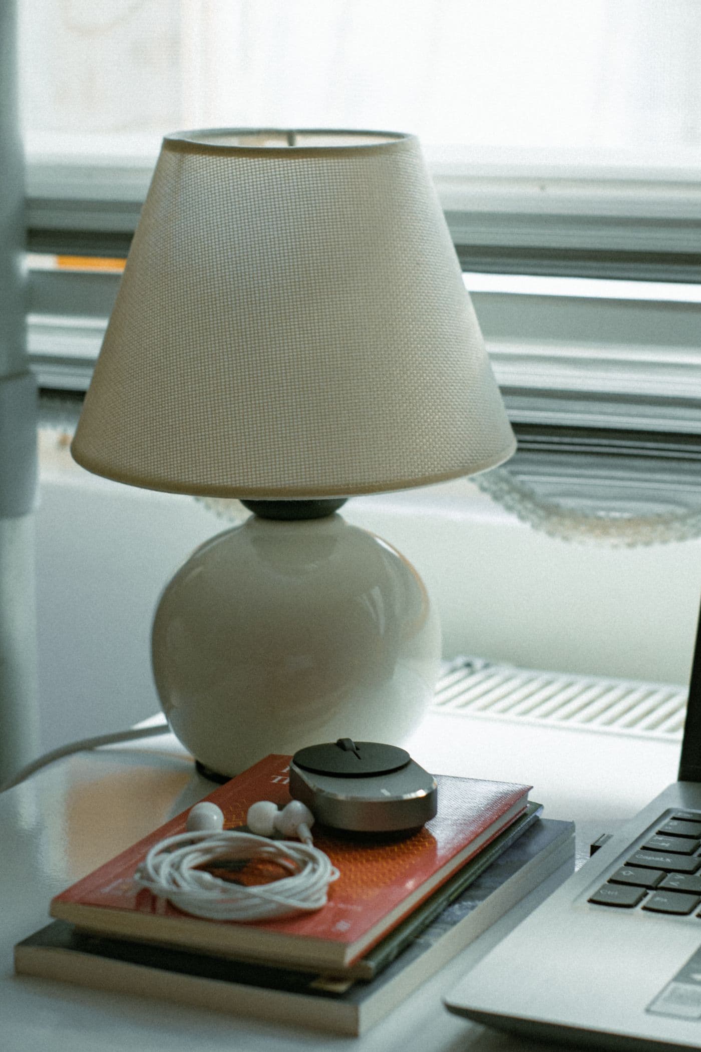 Desk with a lamp, books and a laptop