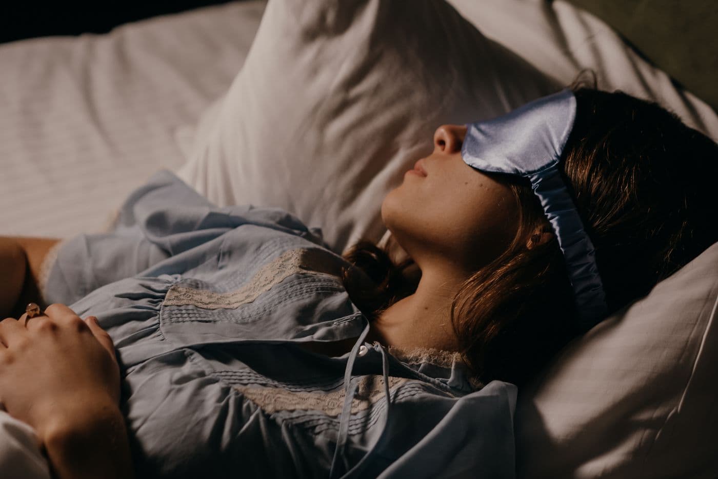 Woman sleeping peacefully with a sleep mask